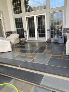 Custom-designed stamped concrete patio featuring a multi-tone stone pattern
