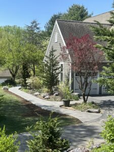 Custom stamped concrete walkway bordered by mulch and greenery