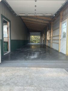 Wide stamped concrete driveway featuring a textured slate pattern