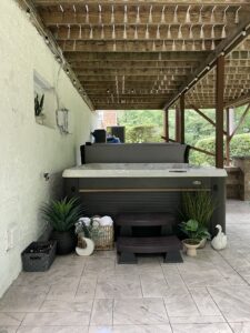 tamped concrete patio surrounding a jacuzzi