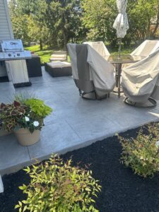 A stamped concrete patio with a natural stone texture
