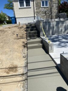 Stamped concrete hardscaping work showcasing a seamless blend with surrounding landscaping.