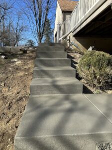 Freshly installed stamped concrete Hardscaping work with slab foundation for a pole barn, demonstrating clean flatwork and professional formwork.